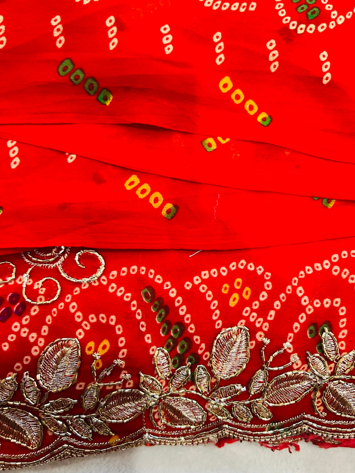 Yellow Bandhani Saree with Red Embroidered Border and Stitched Green Blouse
