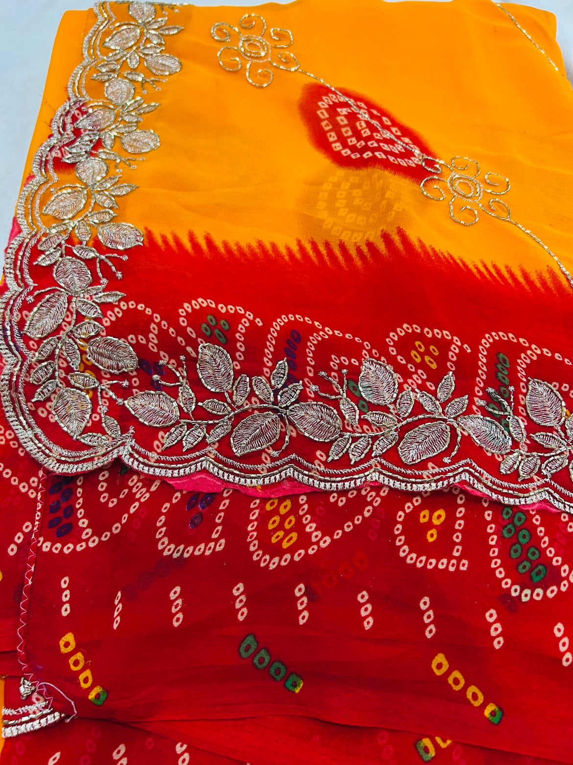 Yellow Bandhani Saree with Red Embroidered Border and Stitched Green Blouse